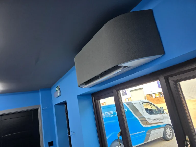 Wall-mounted air conditioner above glass entrance doors