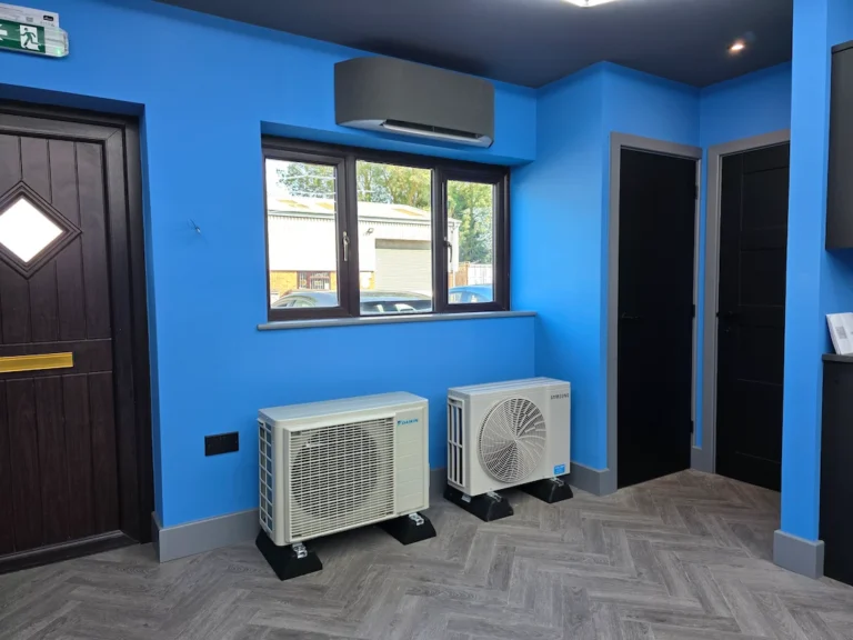Air conditioning units displayed in a bright blue showroom